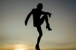 Feel the body. Dancing silhouette. Woman silhouette on evening sky. Dance girl