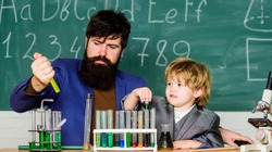 Genius minds. Genius kid. Joys and challenges raising gifted child. Teacher bearded scientist man child test tubes. Chemical experiment. Special and unique. Genius child private lesson. Knowledge day