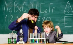 Genius child private lesson. Knowledge day. Genius minds. Genius kid. Joys and challenges raising gifted child. Teacher bearded scientist man child test tubes. Chemical experiment. Special and unique