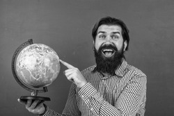 best place. college lecturer on geography lesson. back to school. informal education. happy mature teacher pointing at globe. bearded man geographer work in classroom with map. prepare for exam