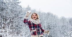Christmas vacation. girl wear mittens keep hands warm. good mood any weather. winter and people concept. having snowball fight. happy woman play snowball outdoor. girl in trendy winter jacket