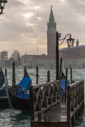 View of Canal Grande with Venice gondola and Basilica di Santa Maria della Salute in Venice, Italy. Architecture and landmarks of Venice.