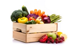 Pine box full of colorful fresh vegetables and fruits on a white background, ideal for a balanced diet, contains broccoli, cucumber, onion, asparagus, peppers, carrots, apple, grape, lima and potatoes