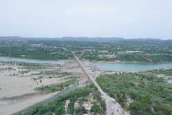Drone shot of Mangla bridge over Jehlum River at the border of Pakistan and Azad Jammu and Kashmir which connects Mirpur and Mangla
