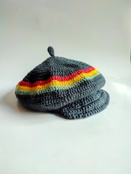 Rasta pattern flat cap with distinctive red, yellow green color stripes, taken with angel front