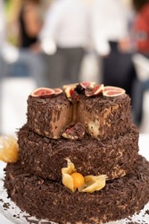 Cake with three chocolate floors on the outside and with fruits decorated on the outside, figs on the top