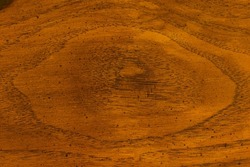 A wood surface with a pattern in the shape of an eye.
