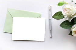 Mockup with envelope, blank card and dry roses.
