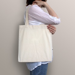 Mock-up. Girl is holding blank cotton tote bag.
