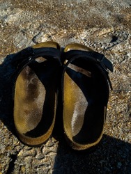 Burkenstock flip flop sandals on St Augustine Beach sand during the Florida December season with sand inside