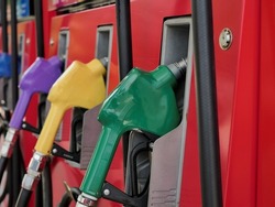 fuel dispenser. The green fuel nozzles are arranged in several colors. Gasoline and diesel service stations. The green fuel dispenser is installed in the red oil dispenser.