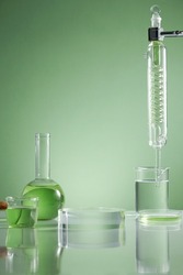 Scientist with chemical reaction in chemistry laboratory. close up of scientist making research in lab in green background , green water in test tube and blank space for advertising , front view