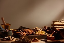 Traditional chinese medicine with herb and spices in light a grey background , for medicine advertising , photography traditional medicine content