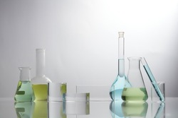 Front view of laboratory equipment filled with colorful fluid in a beaker test tube in lab background for experiment advertising 