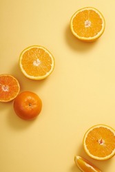 A top view of orange fruit decorated in orange background