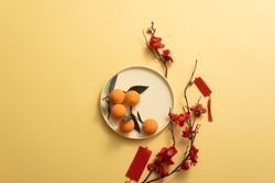 Chinese new year holiday background stylish with tangerine, Blossom, mandarin orange, and lucky ornaments. Empty space for text