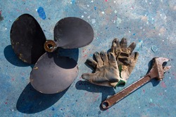 boat propeller improvement tools and gloves during a repair work