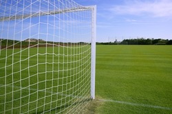 Net soccer goal football green grass field sunny day outdoors
