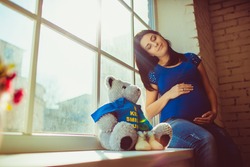 Pregnant woman and teddy bear