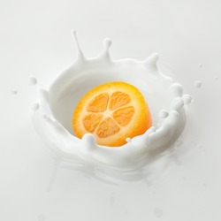Kumquat falls into milk, yoghurt, sour cream, Splash