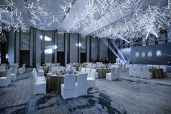 Huge Hall interior with red carpet and ceiling with lights in Hotel. elegant wedding reception table arrangement.