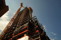 concrete building construction with crane
