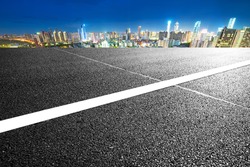 empty asphalt road and cityscape of Nanchang in blue sky at dawn