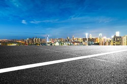 empty asphalt road and cityscape of Nanchang in blue sky at dawn
