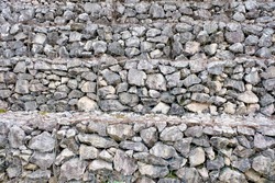 Stonewall texture. gray stones and rocks of different shapes on, the stone wall background.
