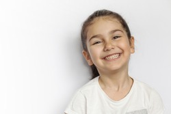 Portrait of happy smiling child girl isolated on white background