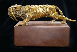Old small gold tiger Statue in bronze. a fantastic figure made from bronze on black background. Antique bronze culture concept. brozen small statue or bronze sculpture.  tiger side, animal statues