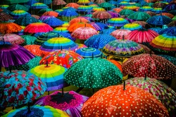 Colorful umbrellas interior top view. Cool rain umbrellas for beach cover background. Blue,Green,Red, Rainbow umbrellas. Summer umbrella Rain protection- cute cover from shower and autumn weather. 