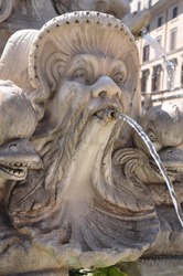 Water fountain face sculpture in Rome, Italy.
