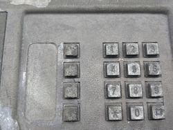 Close up of a dirty public telephone metal keypad. Macro view of the buttons and digits of a public phone keypad.