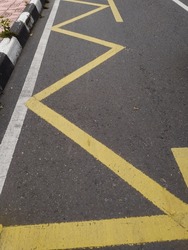 Road markings indicating no stopping or parking