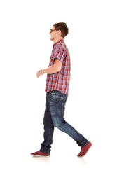 side view of a fashion man walking forward over white