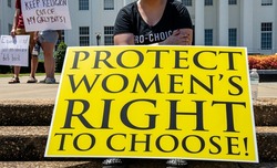 Close up of a Pro-Choice protest sign signifying ongoing protests across the United States with other signs in the background.