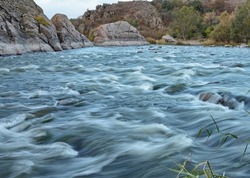 Fast flowing rapids of the Southern Buh River taken with a slow shutter speed, Buh Granite-Steppe Lands, mecca of whitewater rafting in Ukraine