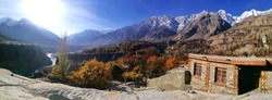Panorama shot of colorful autumn landscape and snow mountain scenery from Altit fort in Hunza valley. Gilgit Baltistan, Pakistan.
