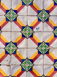 Multicolored diamond ceramic tile pattern on building facade, Lisbon, Portugal.