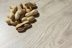 Peanuts on wooden background. Peanuts in shells isolated top view, copy space