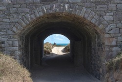 Stone Arch leads through to pristine unspoilt beach on Alderney Channel Islands