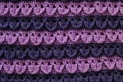 Purple blue knitted texture. Crochet crocodile stitch.