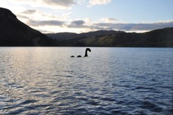 A sticker of Nessie, the Loch Ness monster on the window pane