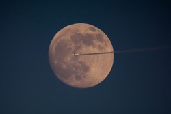 plane flying across the Moon