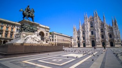 Milan, Italy, April, 2020: empty square in front of the cathedral. Empty streets. Desert city. Piazza Duomo a Milano. Historical architecture. Blue sky
