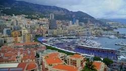 Panoramic view of the port harbor with luxury yachts and sailboats. Cruise ships with tourists from all over the world moor in the main port of the kingdom. Design. August 2022 Monaco. Monte Carlo