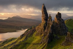 Iconic view of The Old Man of Storr on the Isle of Skye; a popular hiking and walking destination. Beautiful Scotland landscapes. Dramatic clouds with morning light in the mountains.