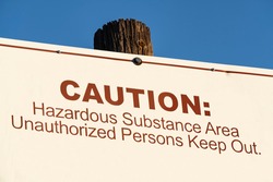 Old caution hazardous substance area unauthorized persons keep out sign.  