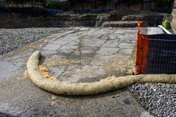 Straw containment barrier on the driveway of a residential construction site
